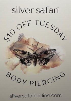 A promotional sign for Silver Safari offering $10 off body piercing on Tuesdays, featuring a detailed moth illustration and listing resources at silversafarionline.com.